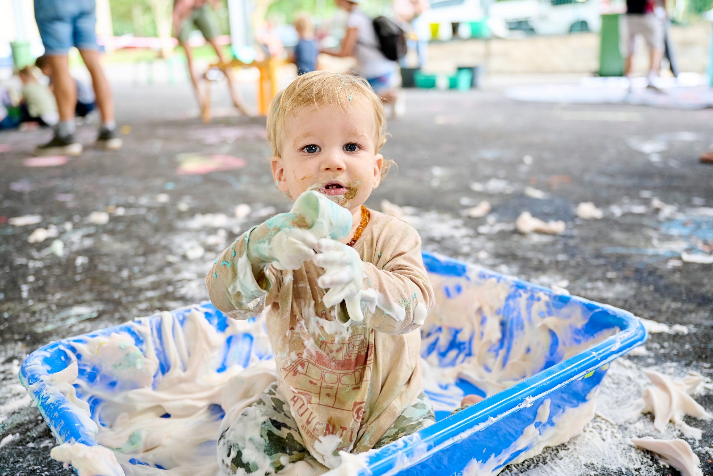 Child playing with shaving cream at the Messy Play Matters event on the Sunshine Coast