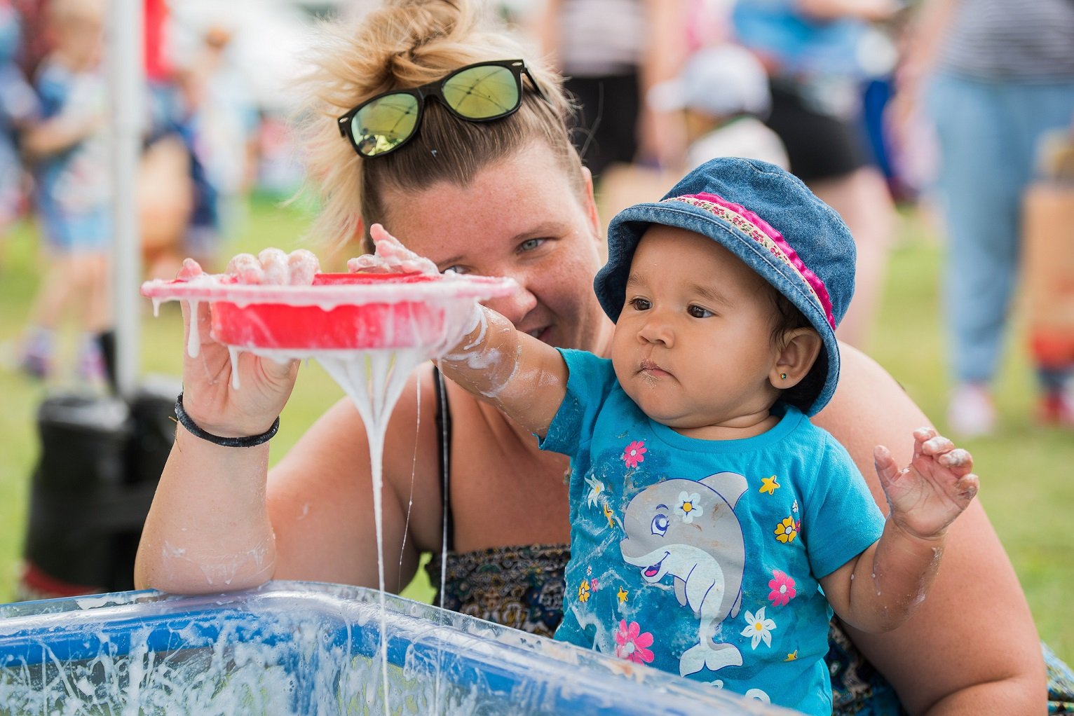 Parent and toddler enjoying slime time at a Messy Play May event