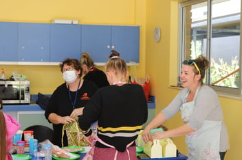 Parents and carers boxing cupcakes at a MyTime group