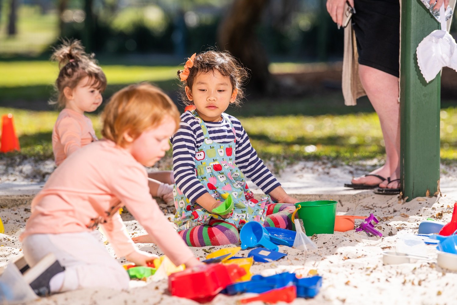 Associative play demonstrated by two children in a sandpit