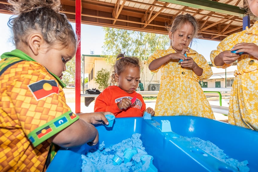 Children in Dajarra engaging in parallel play with moon sand