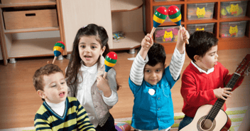 Young children from culturally diverse backgrounds play with maracas at a Sing&Grow music therapy session