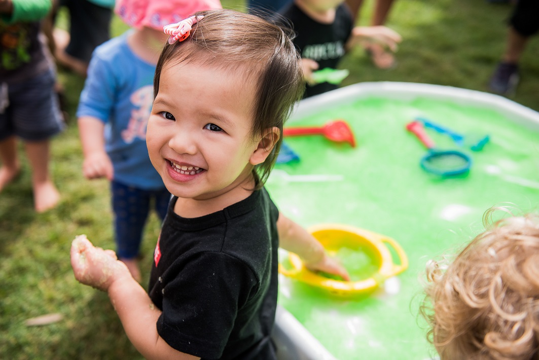 child doing water play at playgroup