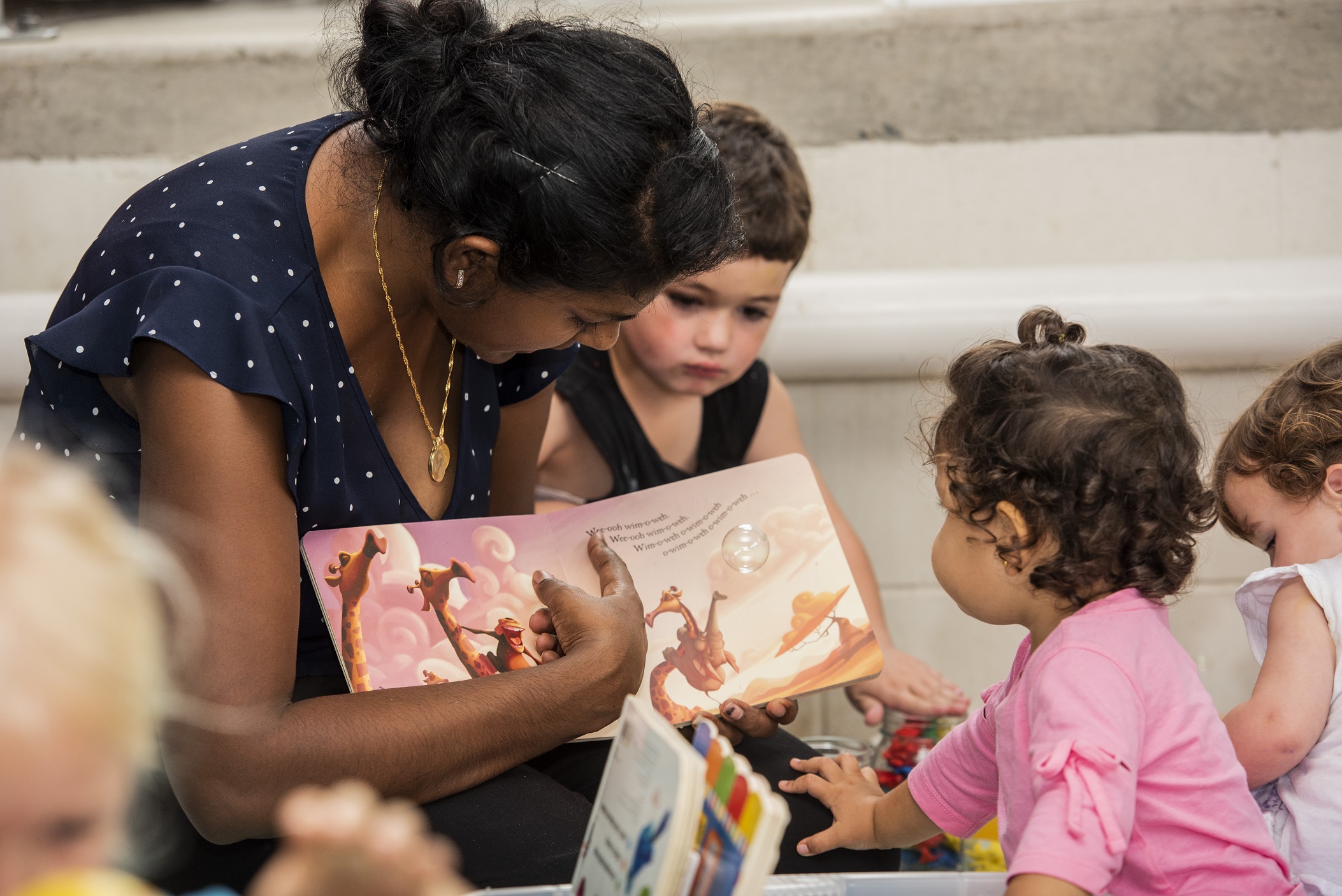 Parent and child reading a book together at the Play Matters Australia Cairns Hub