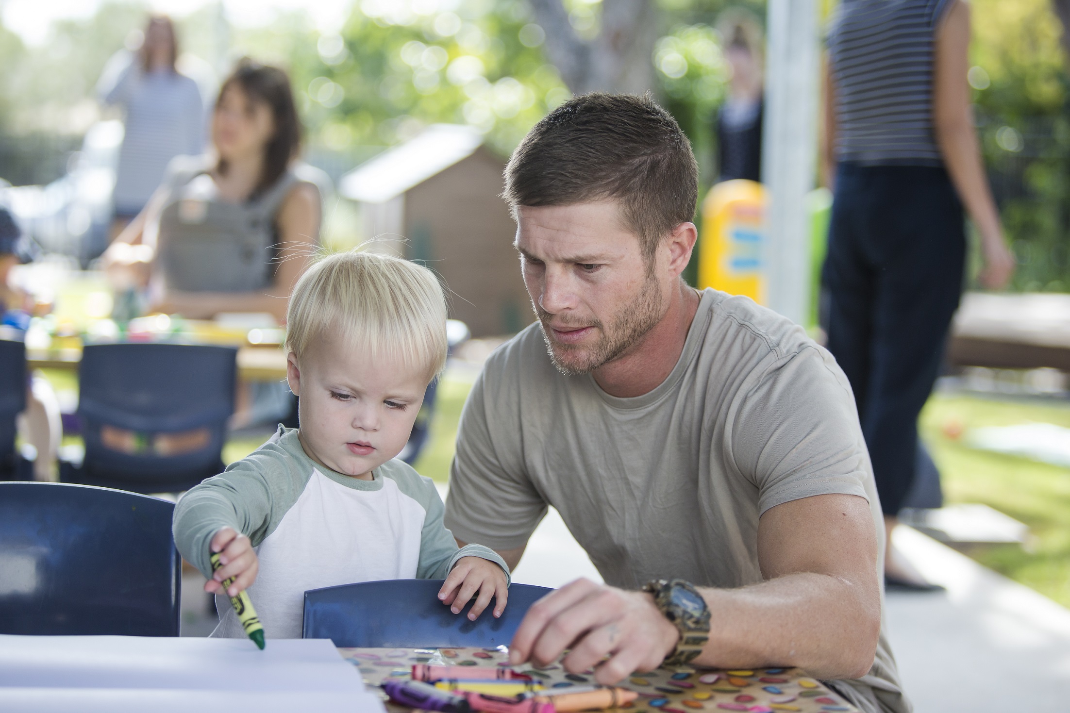 Parent and child drawing together using crayons at the Redland Bayside Child & Family Support Hub