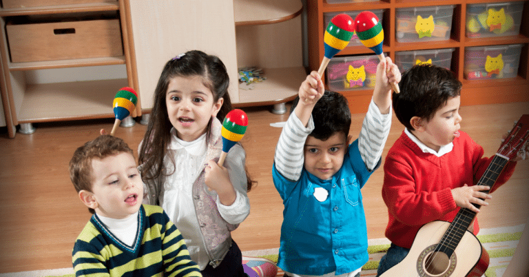 Young children from culturally diverse backgrounds play with maracas at a Sing&Grow music therapy session
