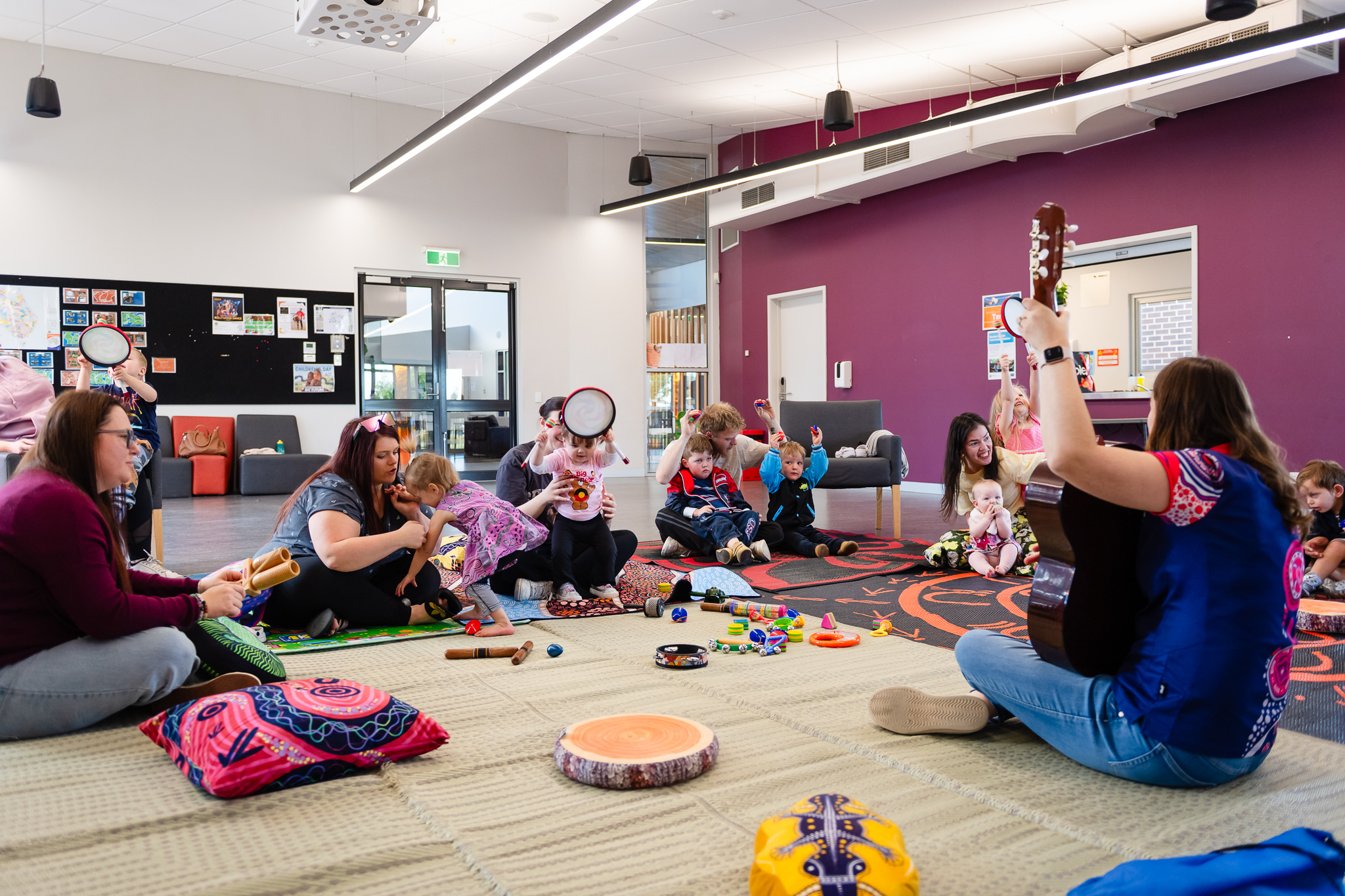 A group of families gather for sing&Grow group music therapy at a community organisation in Victoria.